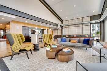 a living room filled with furniture and a large window